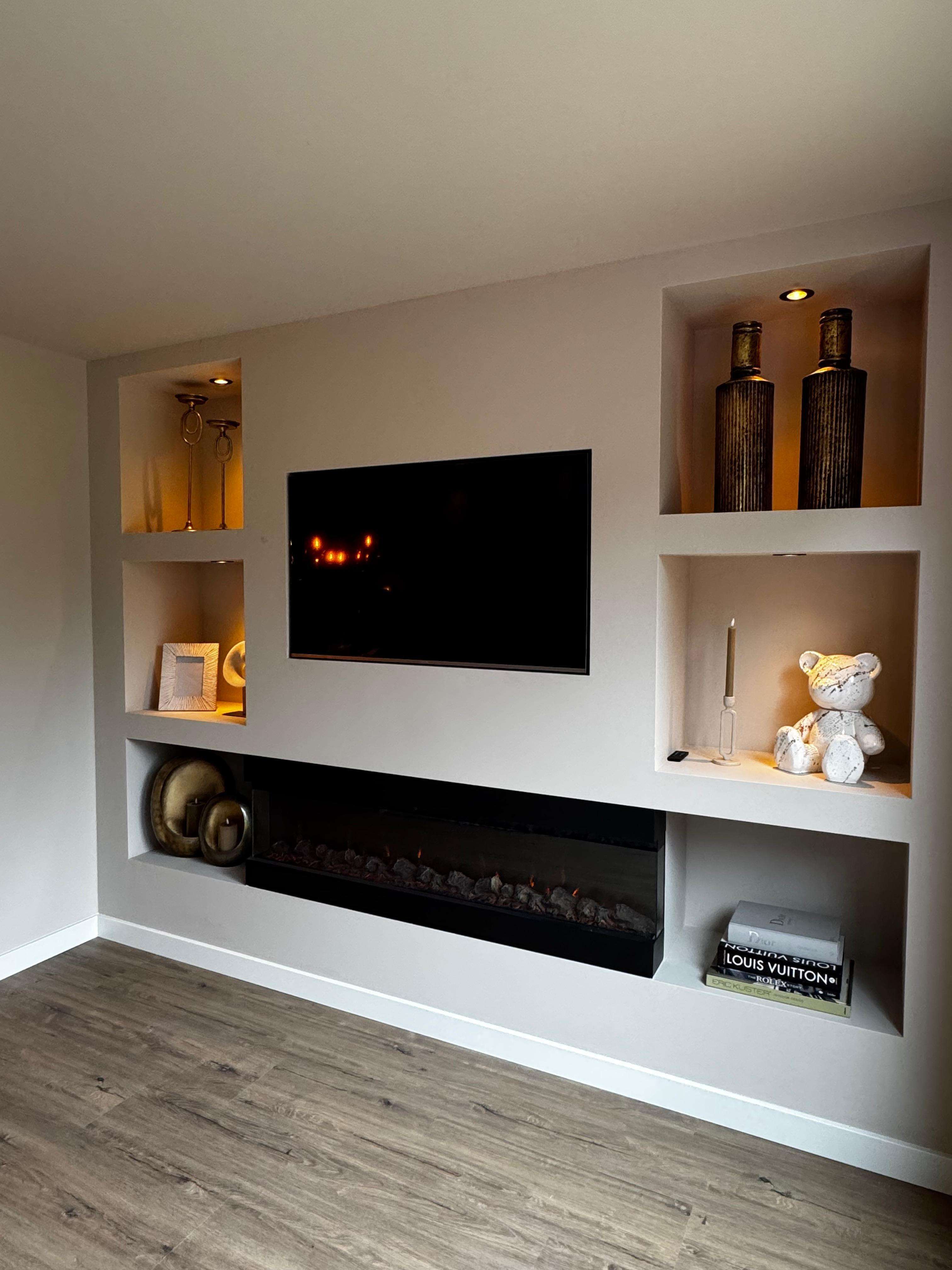 TV-wand met inbouwhaard en verlichte nissen met decoratie